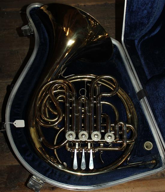 Brass French horn in case